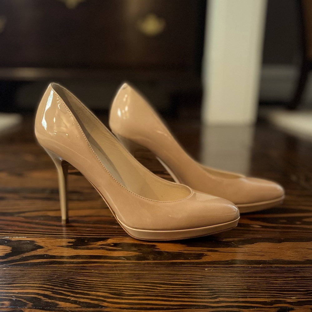 Jimmy Choo nude patent leather platform stiletto pumps.
